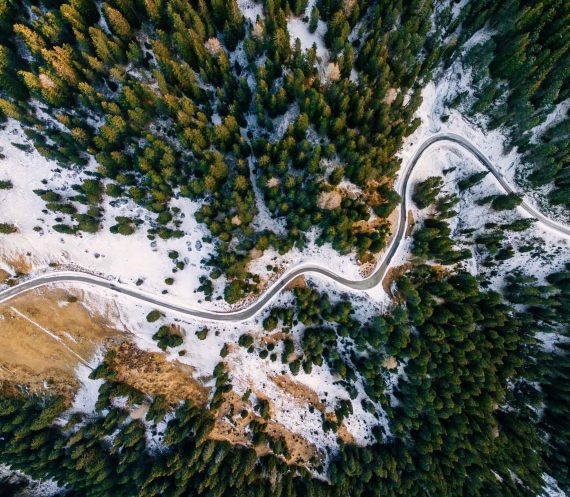 aerial-view-of-snowy-forest-with-a-road-captured-f-PAUZRF7.jpg